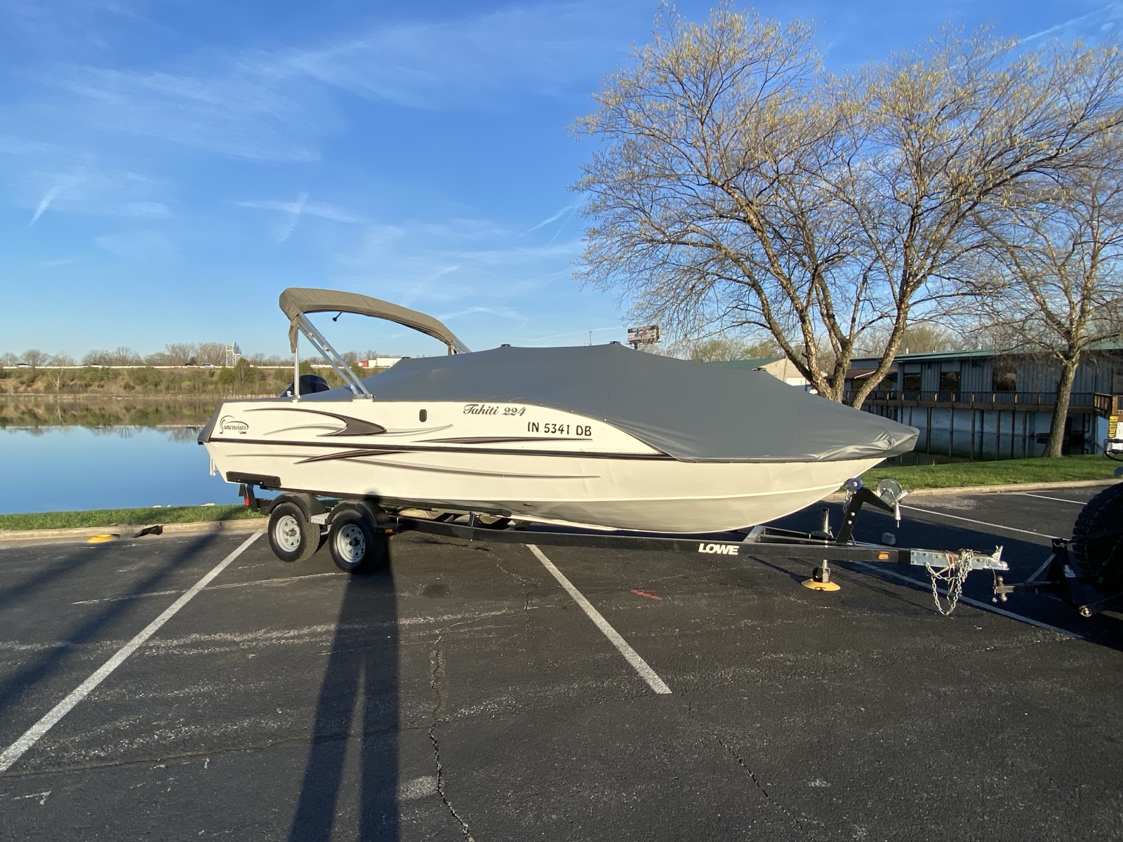 Custom deck boat cover with bimini at golden hour