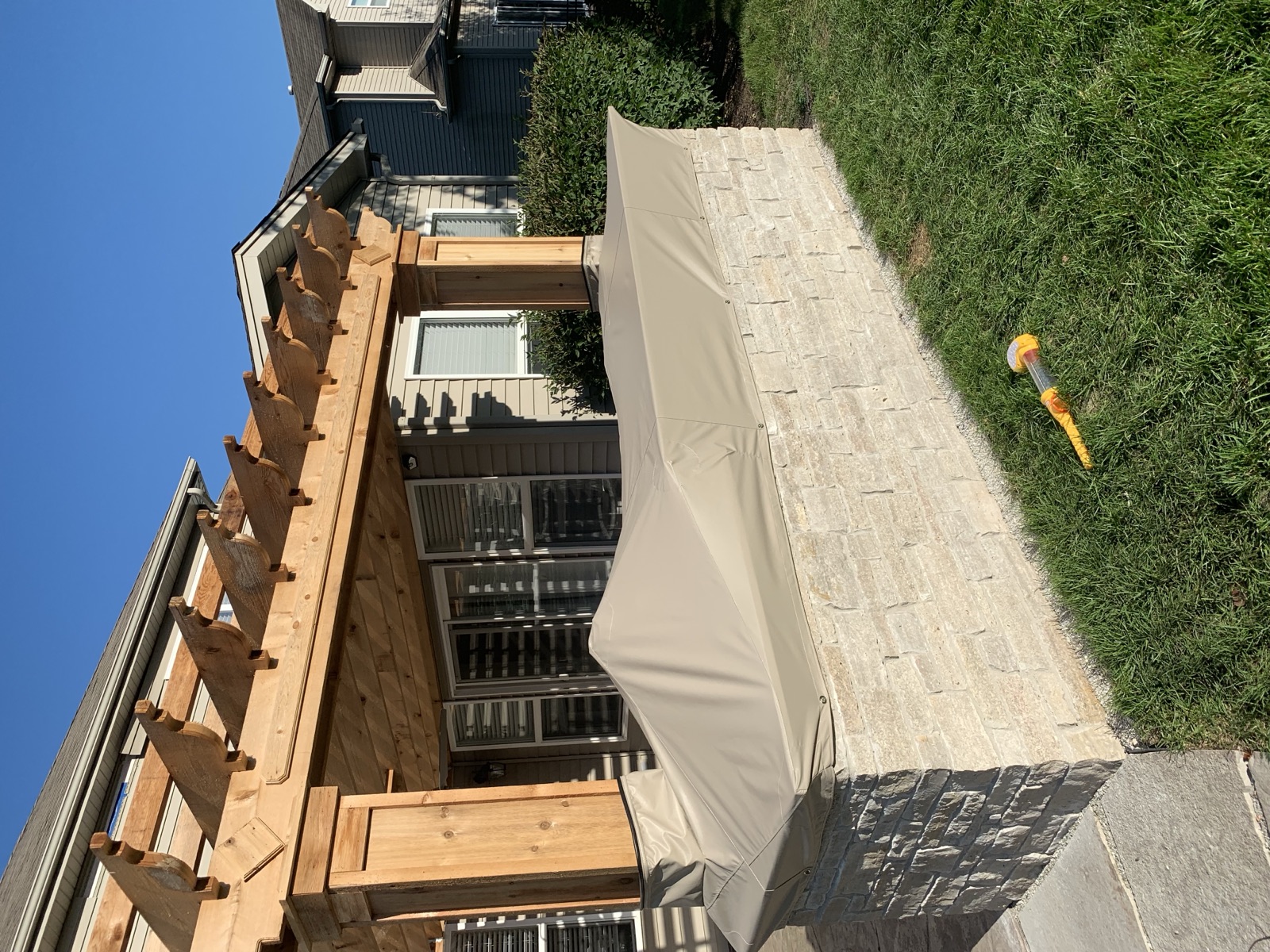 Custom outdoor kitchen cover under cedar pergola