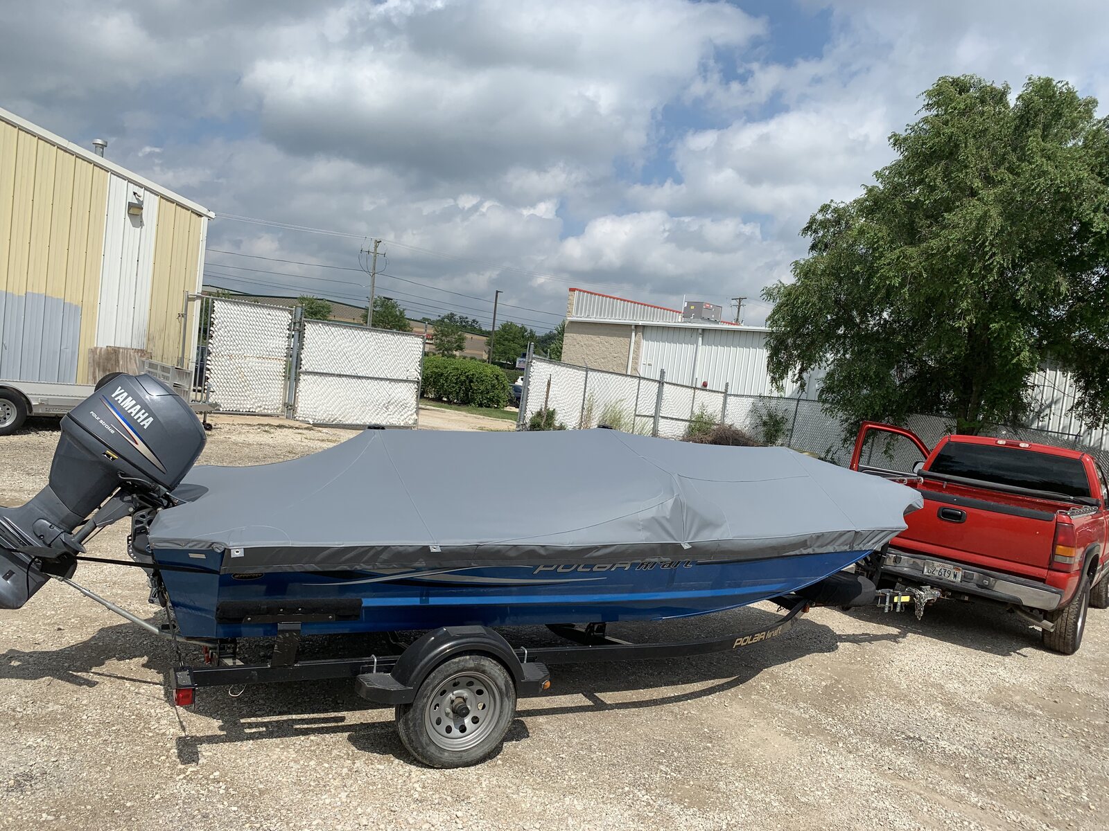 Charcoal cover on a blue-hull boat outdoors