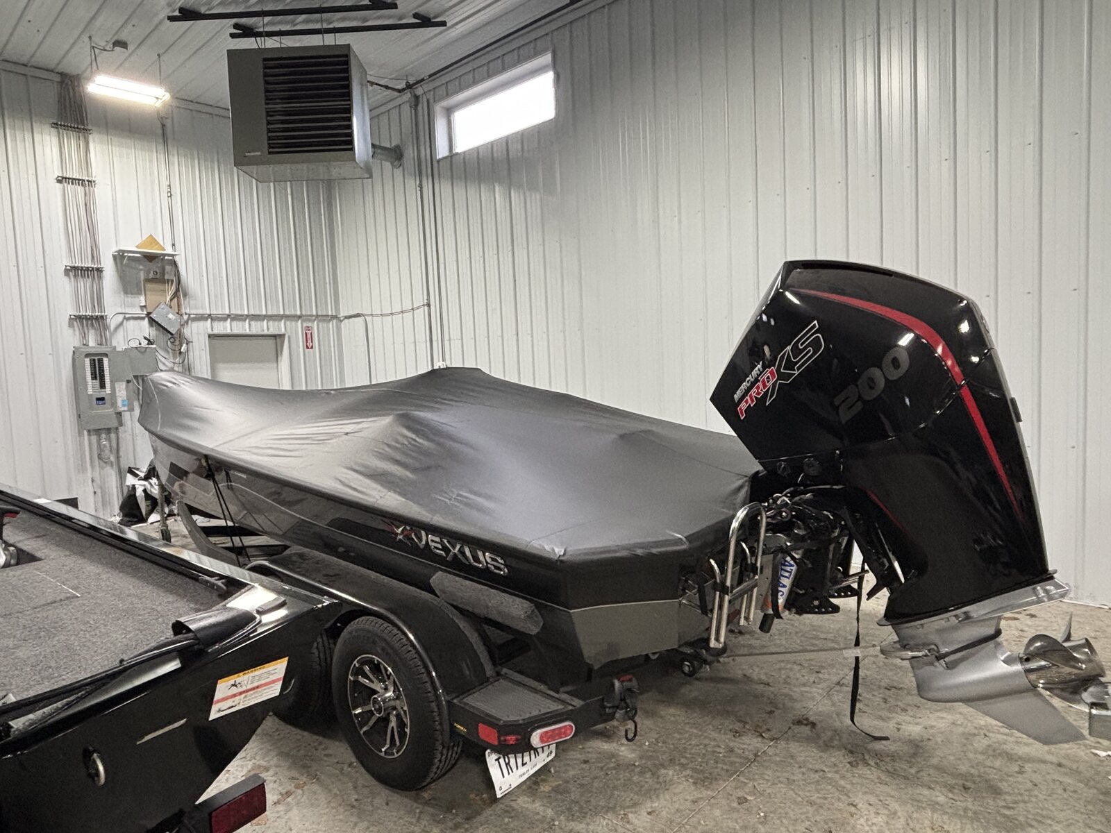 Charcoal fitted cover on a boat with the outboard up