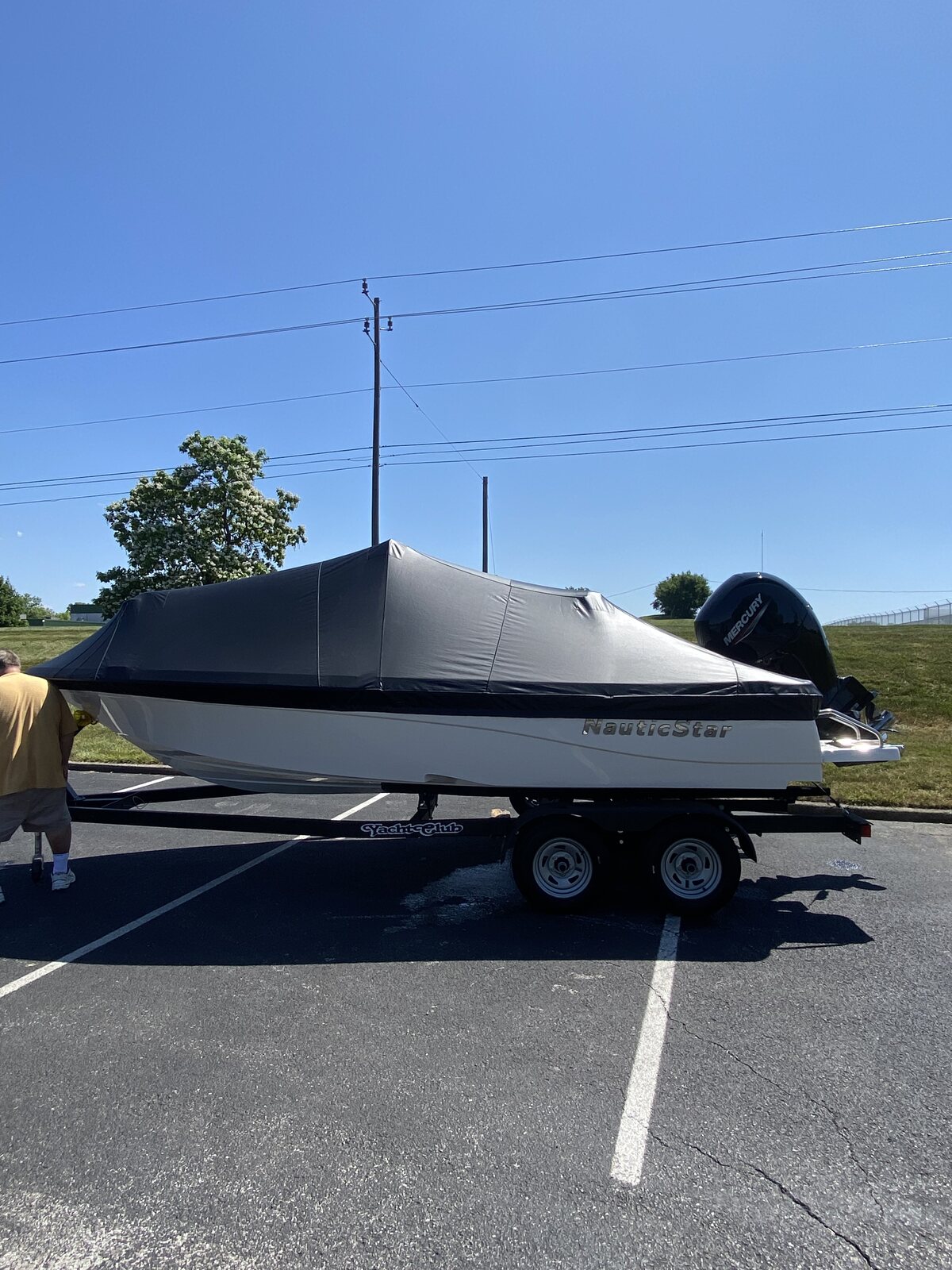 Black custom fitted cover on a Monterey bowrider under blue sky