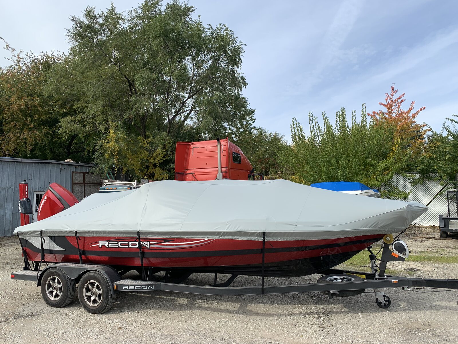 Gray custom fitted cover on a red Recon deck boat
