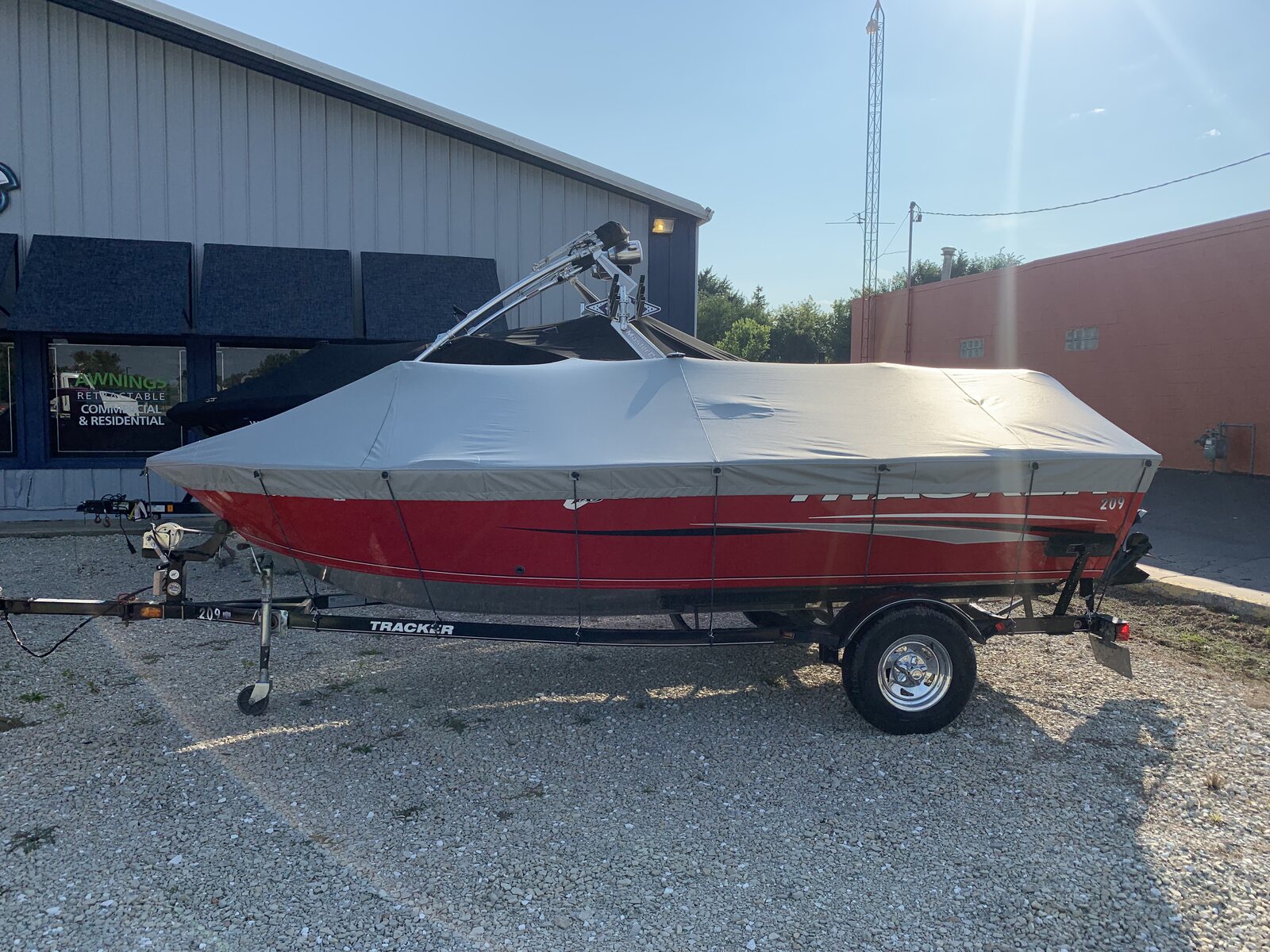 Gray custom cover cut to fit a boat with a wakeboard tower