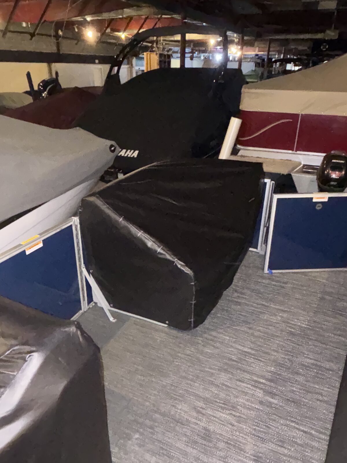 Black fitted cover on a pontoon indoors