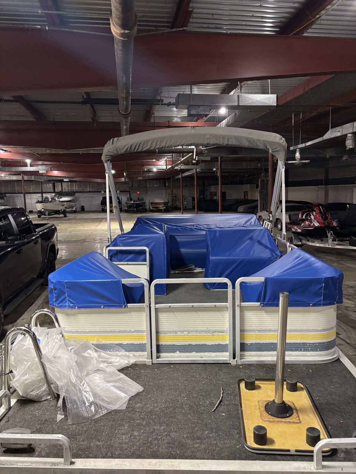 Blue custom seat covers on a striped pontoon