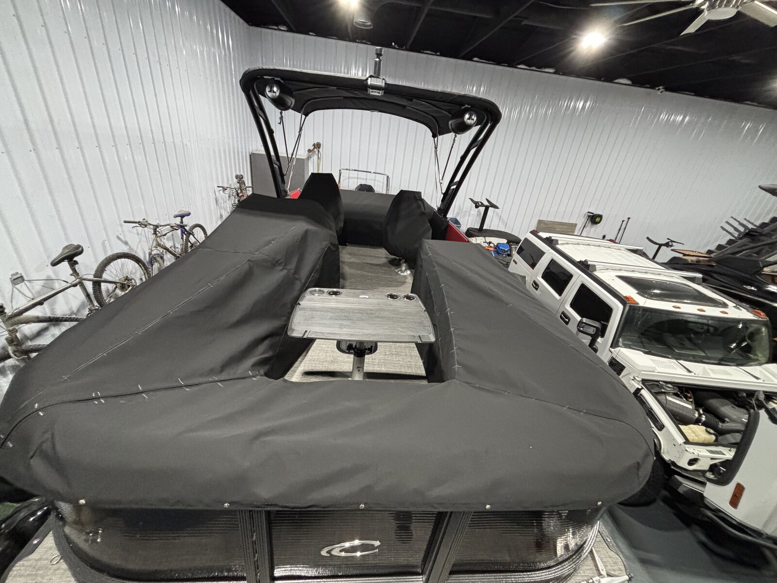 Black custom mooring cover with bimini on a pontoon in a showroom