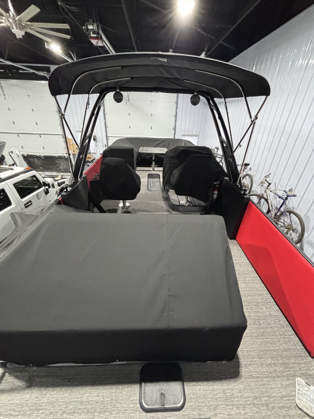 Black playpen cover with the bimini up on a pontoon