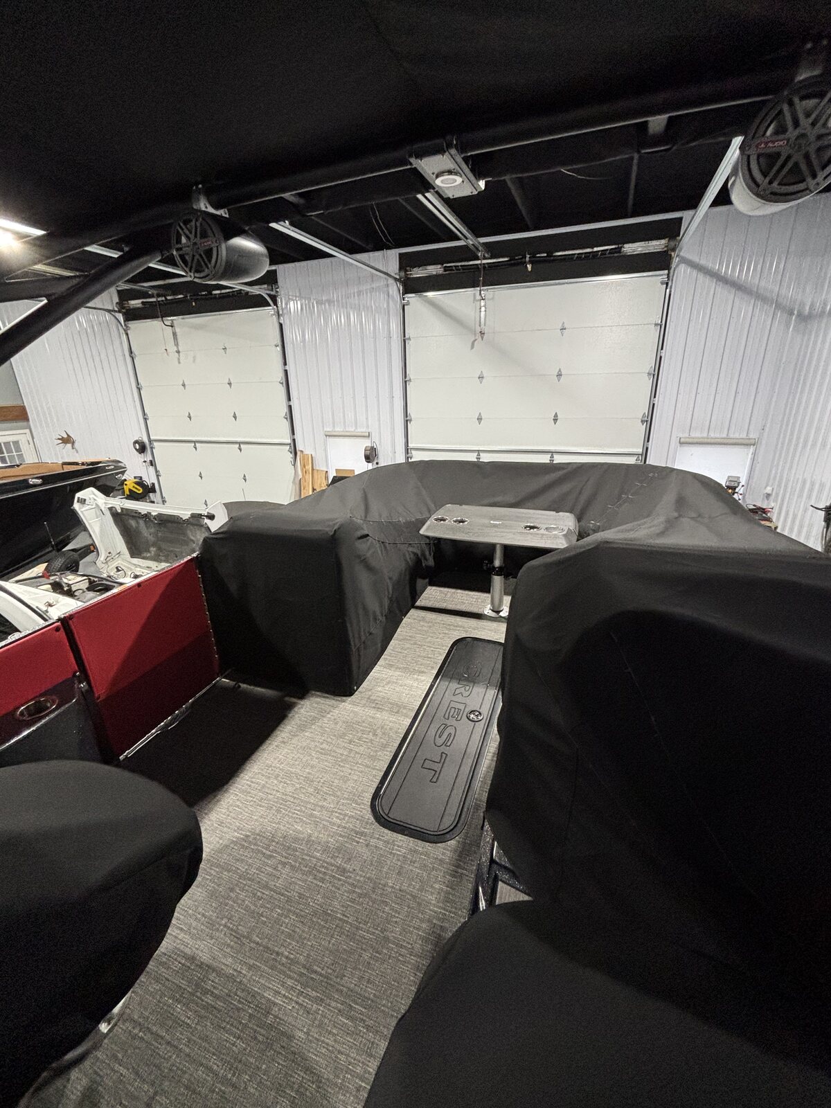 Black fitted seat cover over pontoon furniture